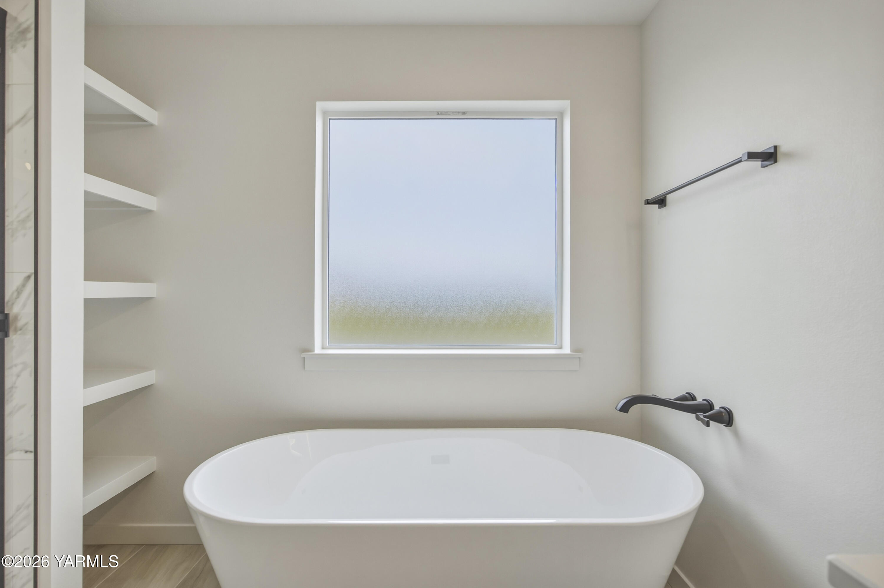 215 Packer Street Prosser, WA 99350 - Photo 24 of 45 a white bath tub sitting next to a small window