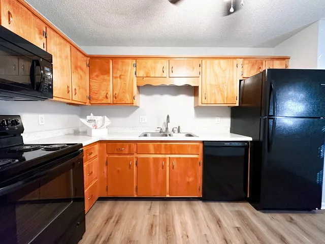 a kitchen with stainless steel appliances granite countertop a refrigerator and a sink