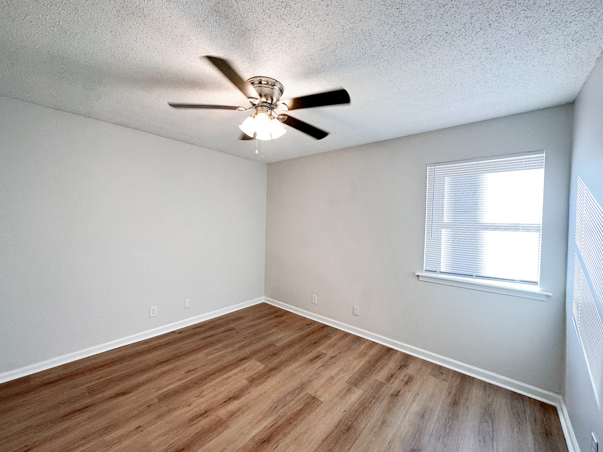 470 Martha Lane, Unit B Clarksville, TN 37043 - Photo 16 of 27 a view of empty room with wooden floor and fan