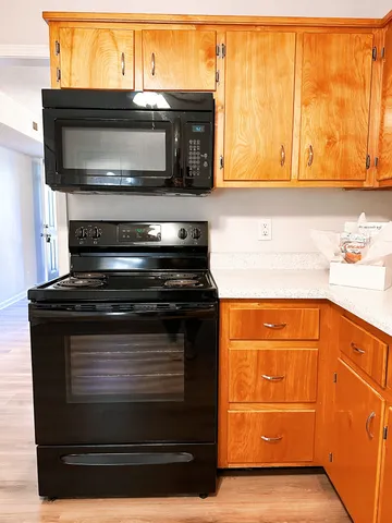 a kitchen with stainless steel appliances granite countertop a stove and a microwave