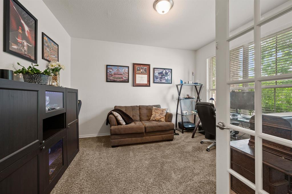 15817 White Mill Road Fort Worth, TX 76177 - Photo 4 of 27 a living room with furniture a flat screen tv and a floor to ceiling window