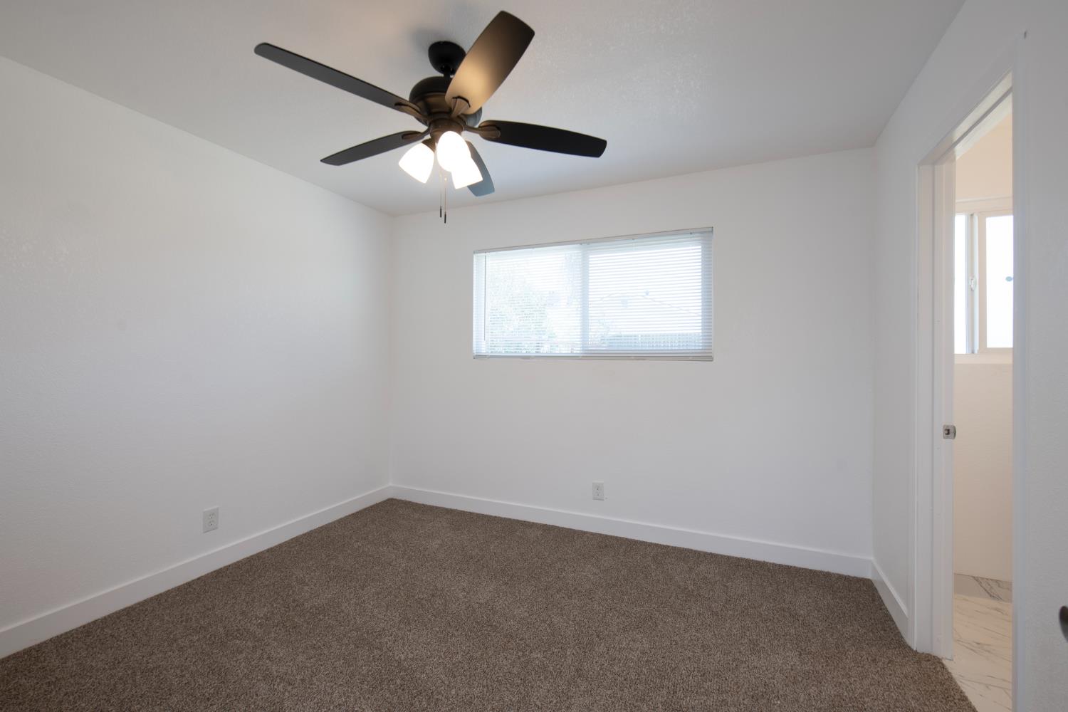266 L Street Mendota, CA 93640 - Photo 15 of 21 an empty room with a window and a fan