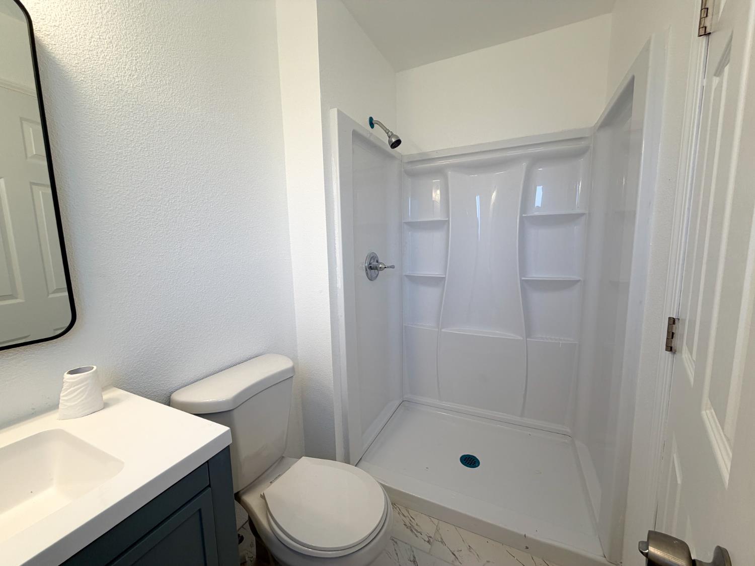 266 L Street Mendota, CA 93640 - Photo 18 of 21 a bathroom with a sink a toilet and shower