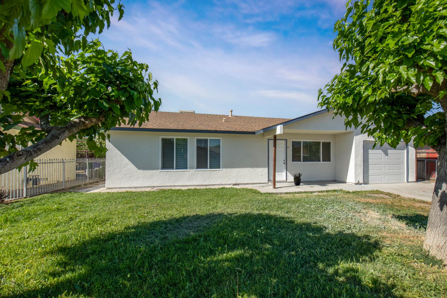 266 L Street Mendota, CA 93640 - Photo 2 of 21 a front view of a house with a garden and yard