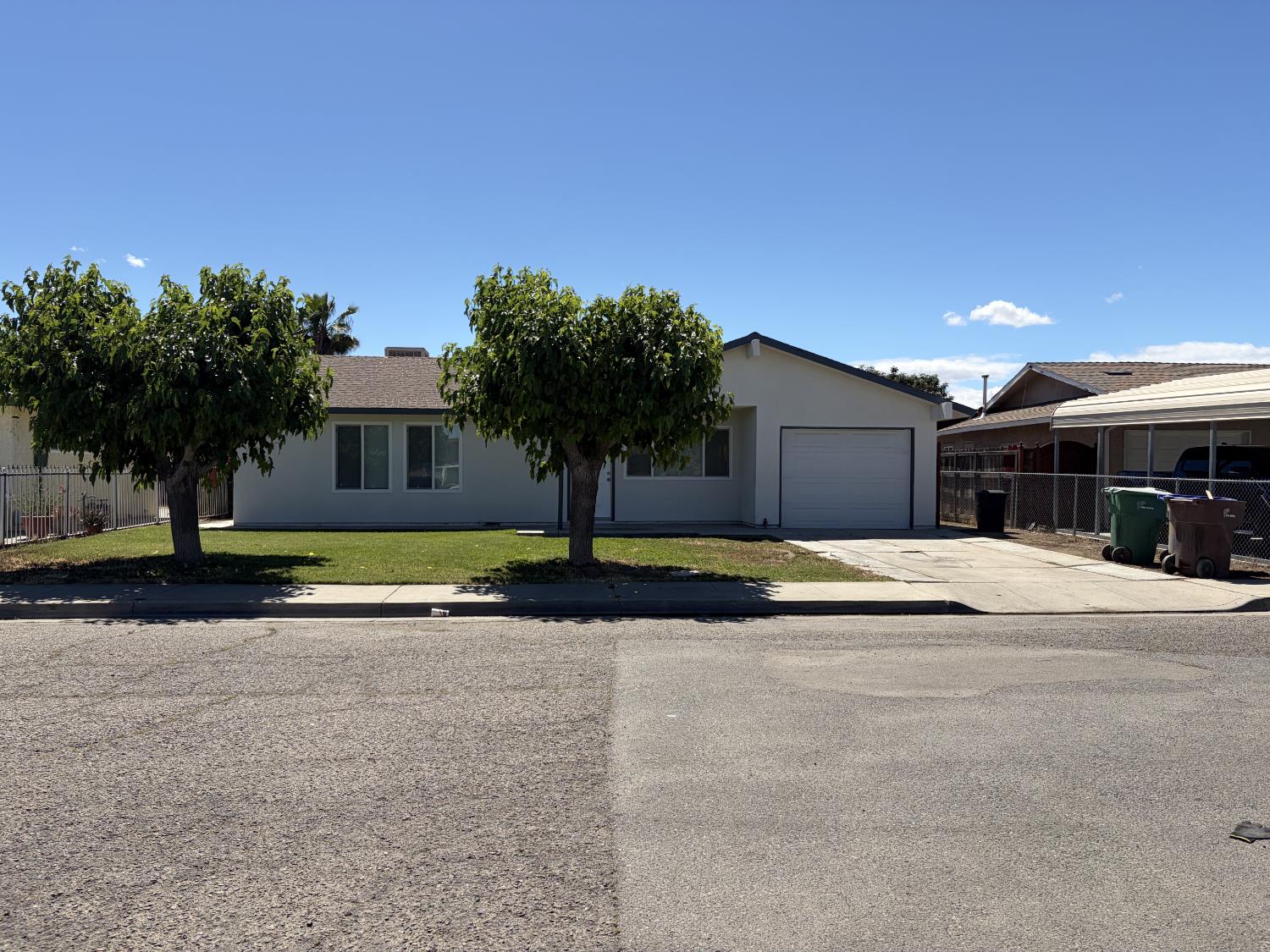 266 L Street Mendota, CA 93640 - Photo 3 of 21 a view of the house with a yard and palm trees