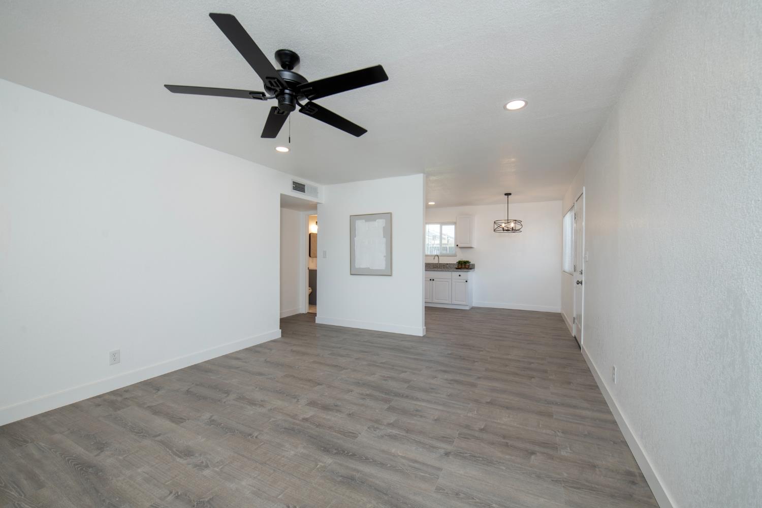 266 L Street Mendota, CA 93640 - Photo 6 of 21 a view of a livingroom with a ceiling fan and wooden floor