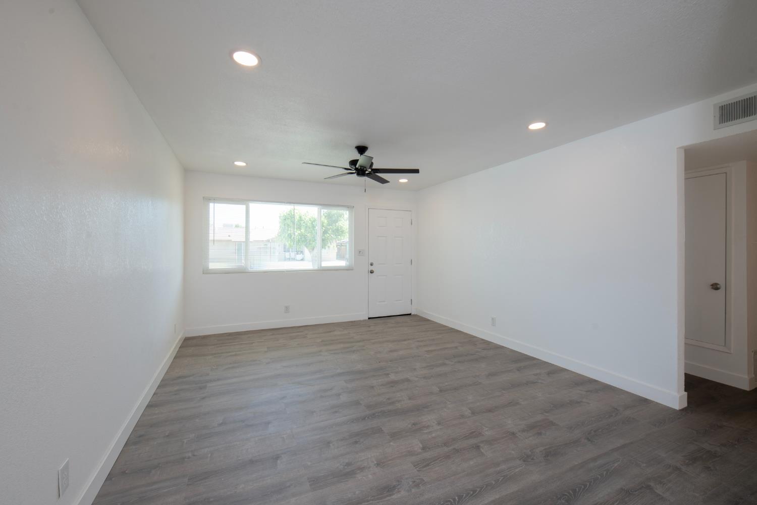 266 L Street Mendota, CA 93640 - Photo 7 of 21 an empty room with wooden floor cabinet and windows