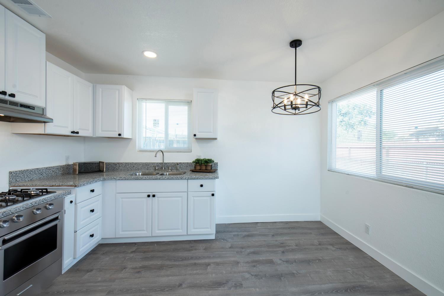 266 L Street Mendota, CA 93640 - Photo 8 of 21 a kitchen with granite countertop a sink cabinets and window