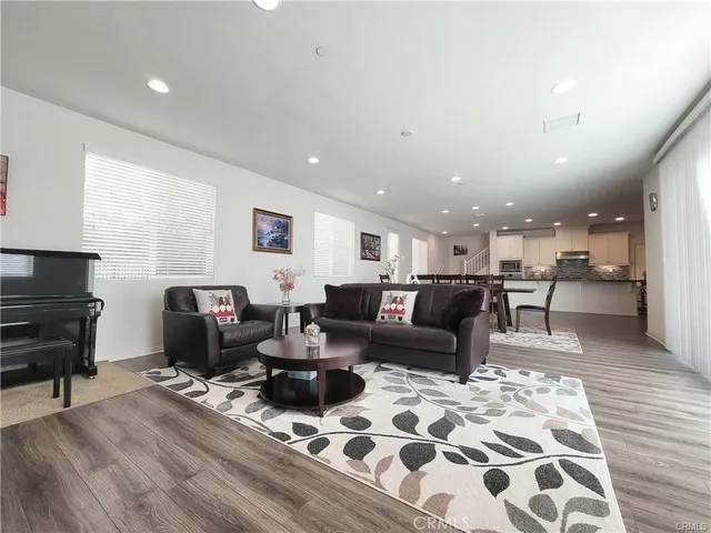 a living room with furniture and a piano