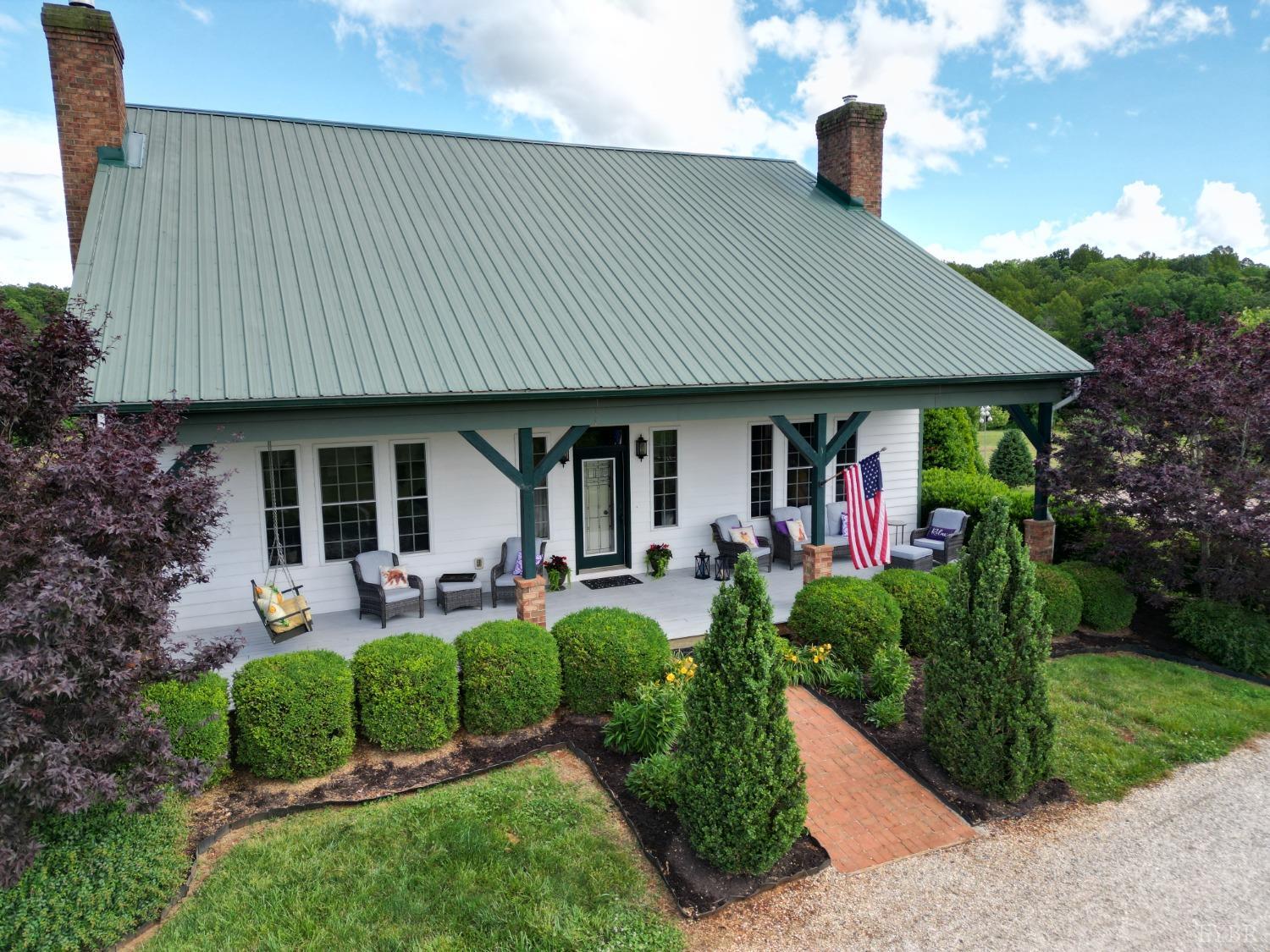 a front view of a house with garden and porch