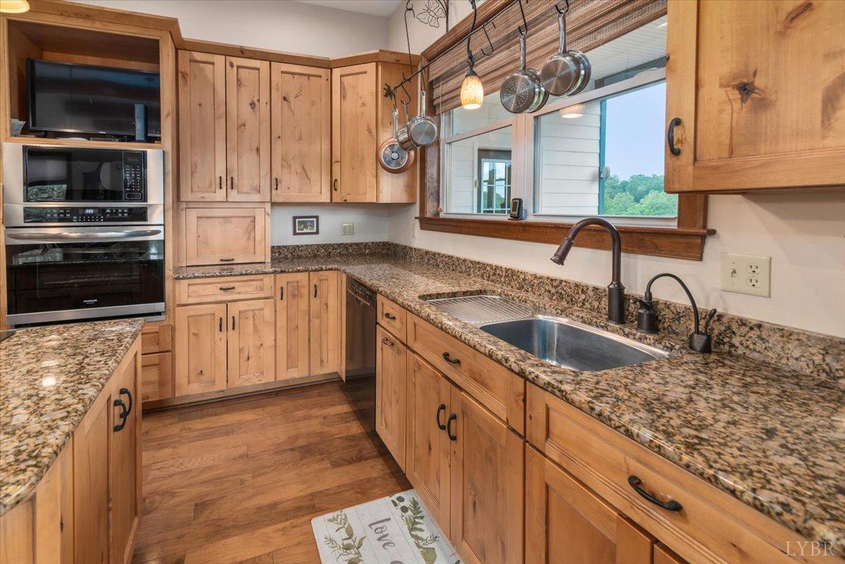 566 White Tail Road Concord, VA 24538 - Photo 15 of 25 a kitchen with stainless steel appliances granite countertop a sink stove and cabinets