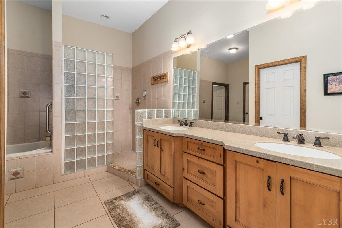 566 White Tail Road Concord, VA 24538 - Photo 18 of 25 a spacious bathroom with a double vanity sink a mirror and a shower