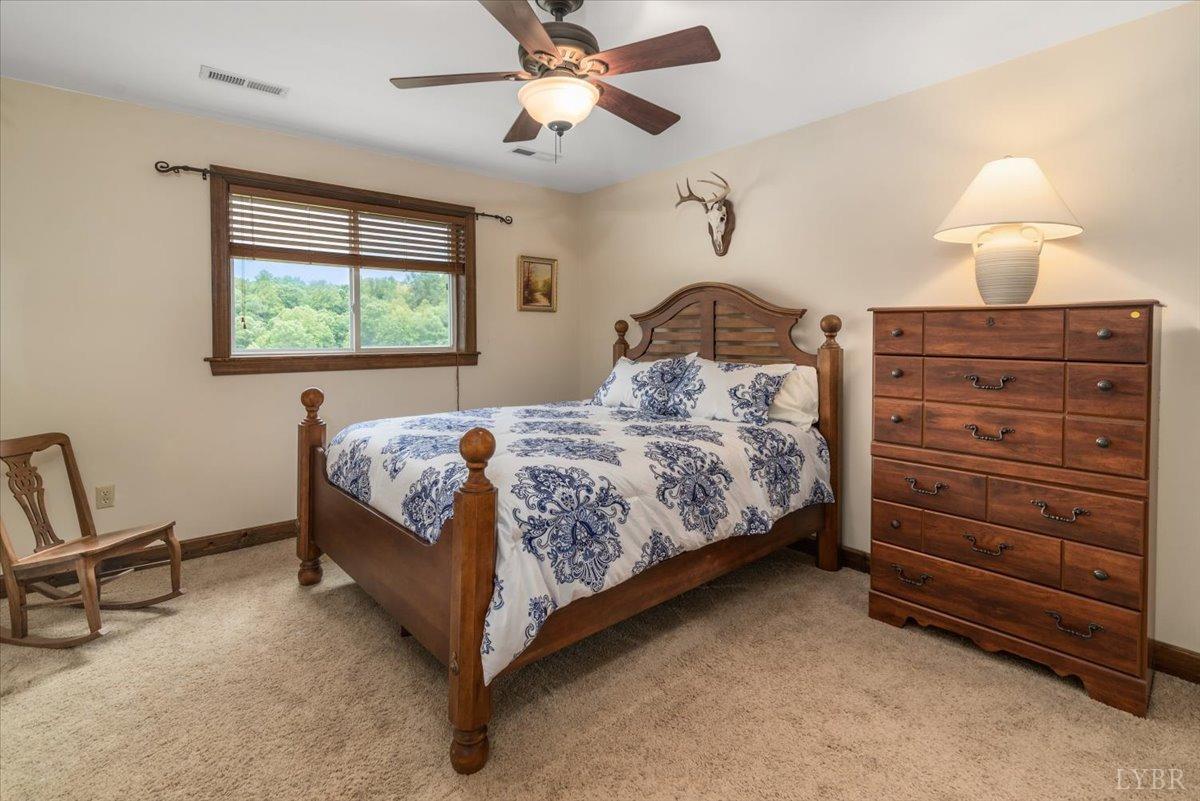 566 White Tail Road Concord, VA 24538 - Photo 19 of 25 a bedroom with a bed and a chandelier