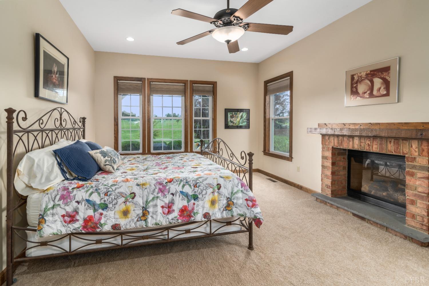 566 White Tail Road Concord, VA 24538 - Photo 8 of 25 a bedroom with a bed and a fireplace