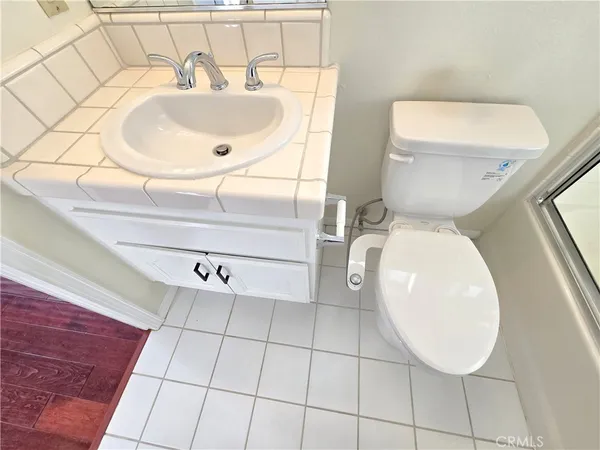 a bathroom with a sink mirror and toilet