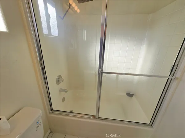 a bathroom with a glass shower door
