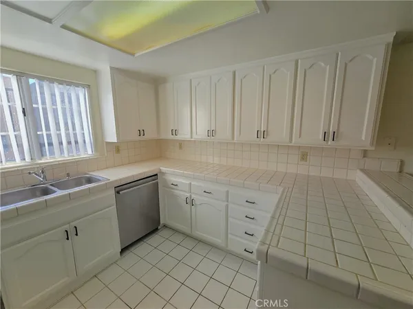 a kitchen that has a sink and a stove in it