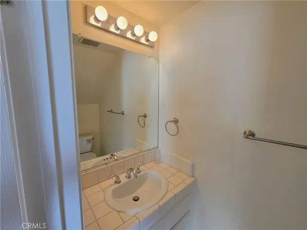 a bathroom with a sink mirror and vanity