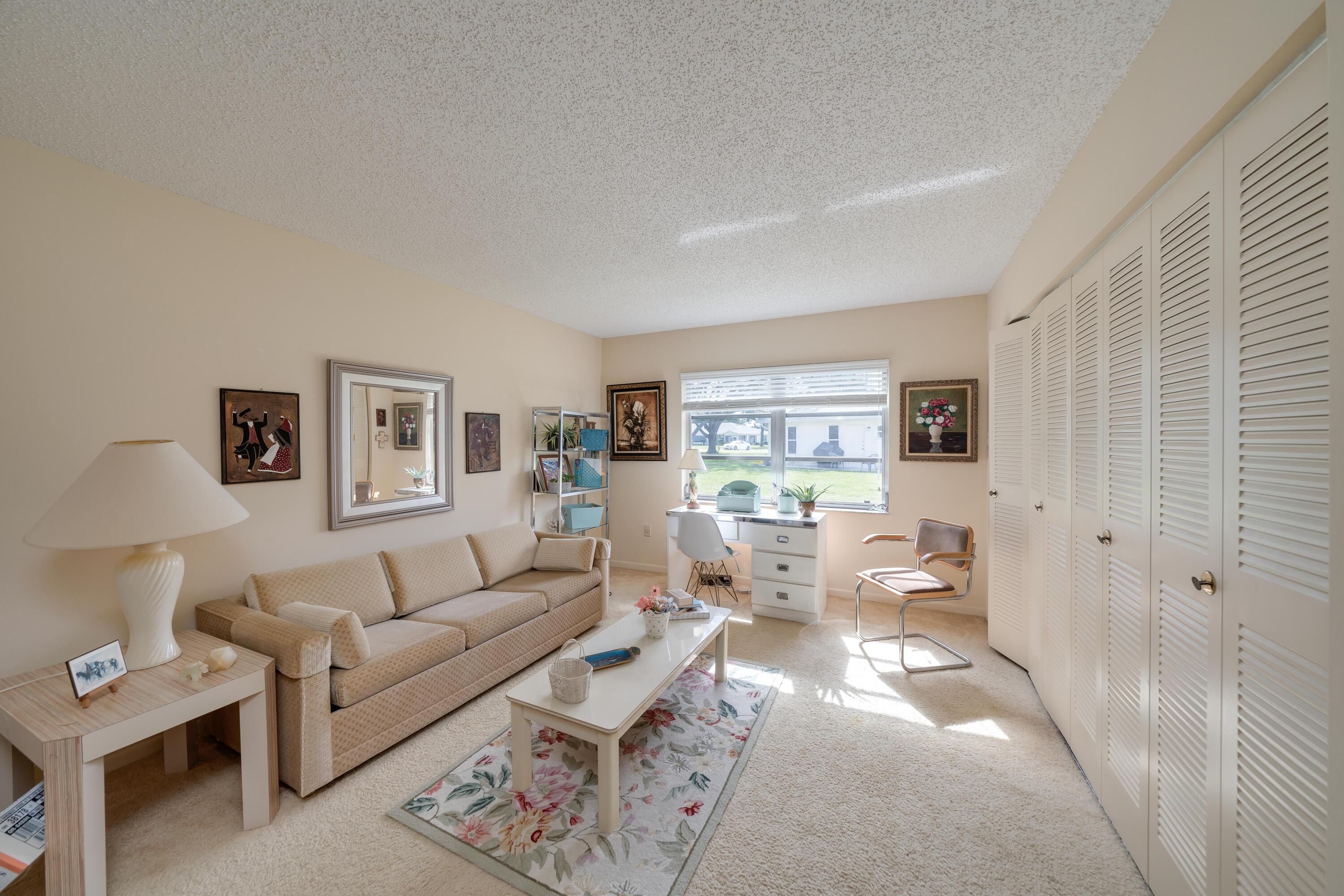 14240 Nesting Way, Unit D Delray Beach, FL 33484 - Photo 22 of 45 a living room with furniture and a window