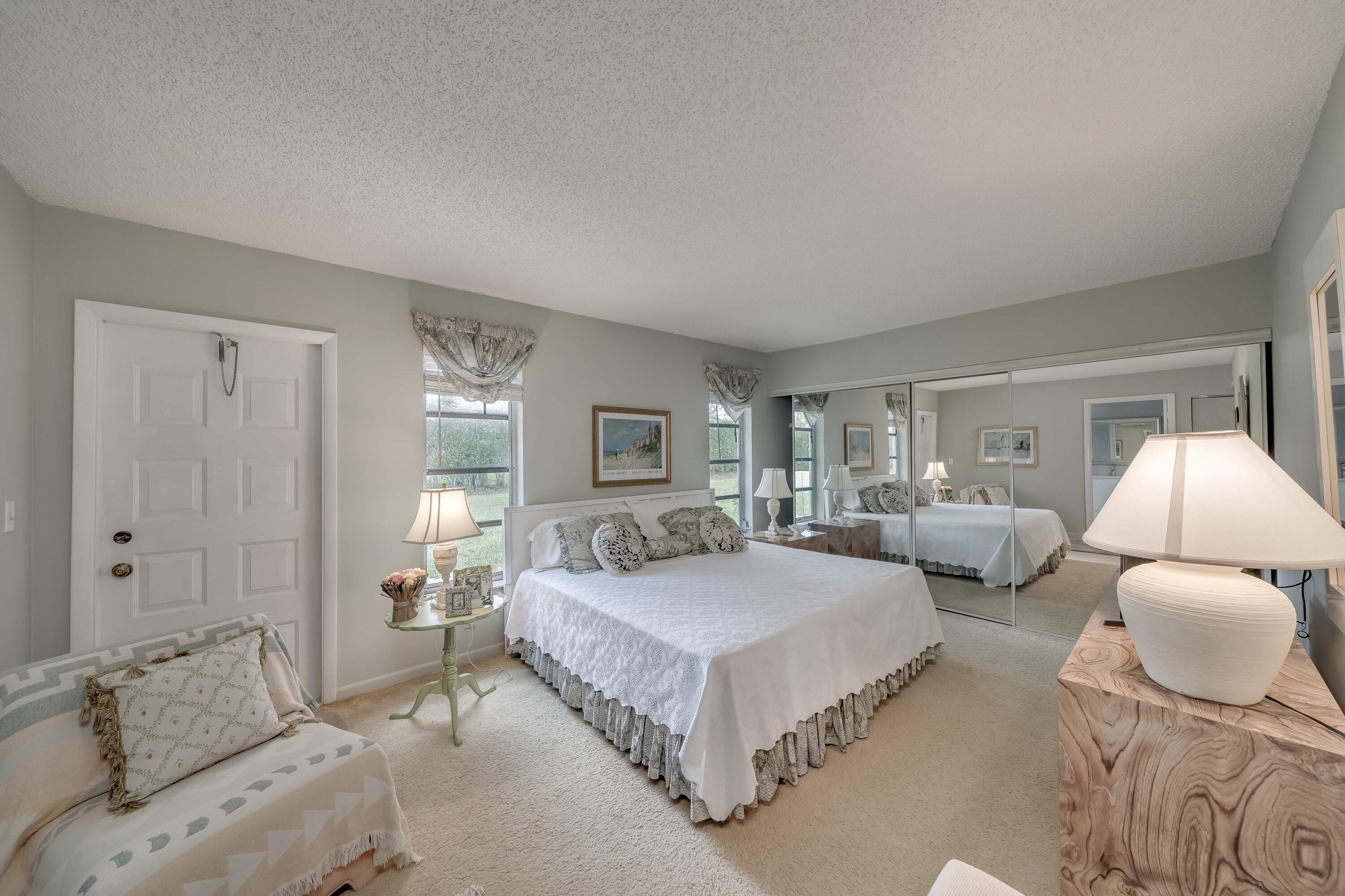 14240 Nesting Way, Unit D Delray Beach, FL 33484 - Photo 24 of 45 a spacious bedroom with a bed and window