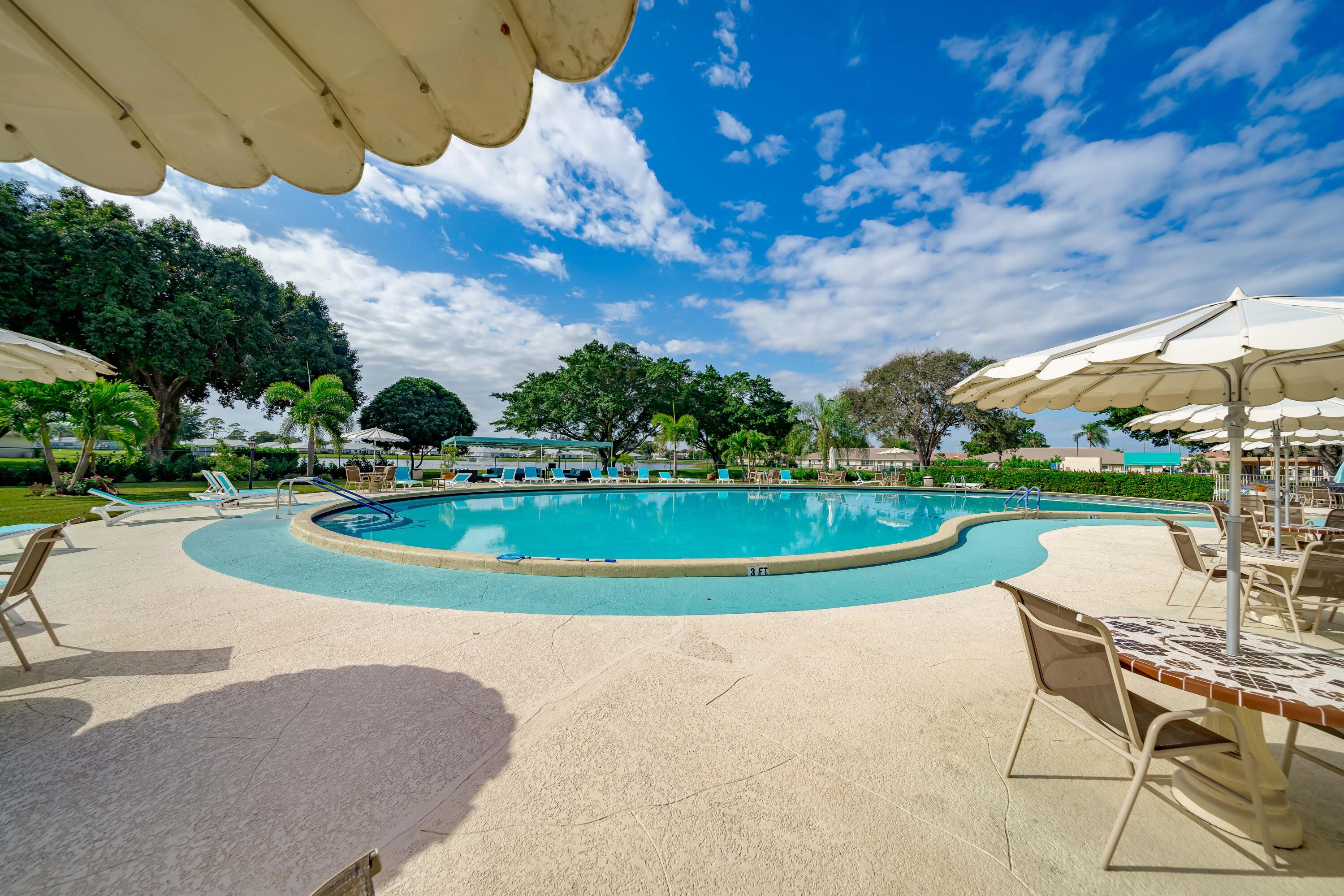 14240 Nesting Way, Unit D Delray Beach, FL 33484 - Photo 45 of 45 a view of a swimming pool with lounge chair