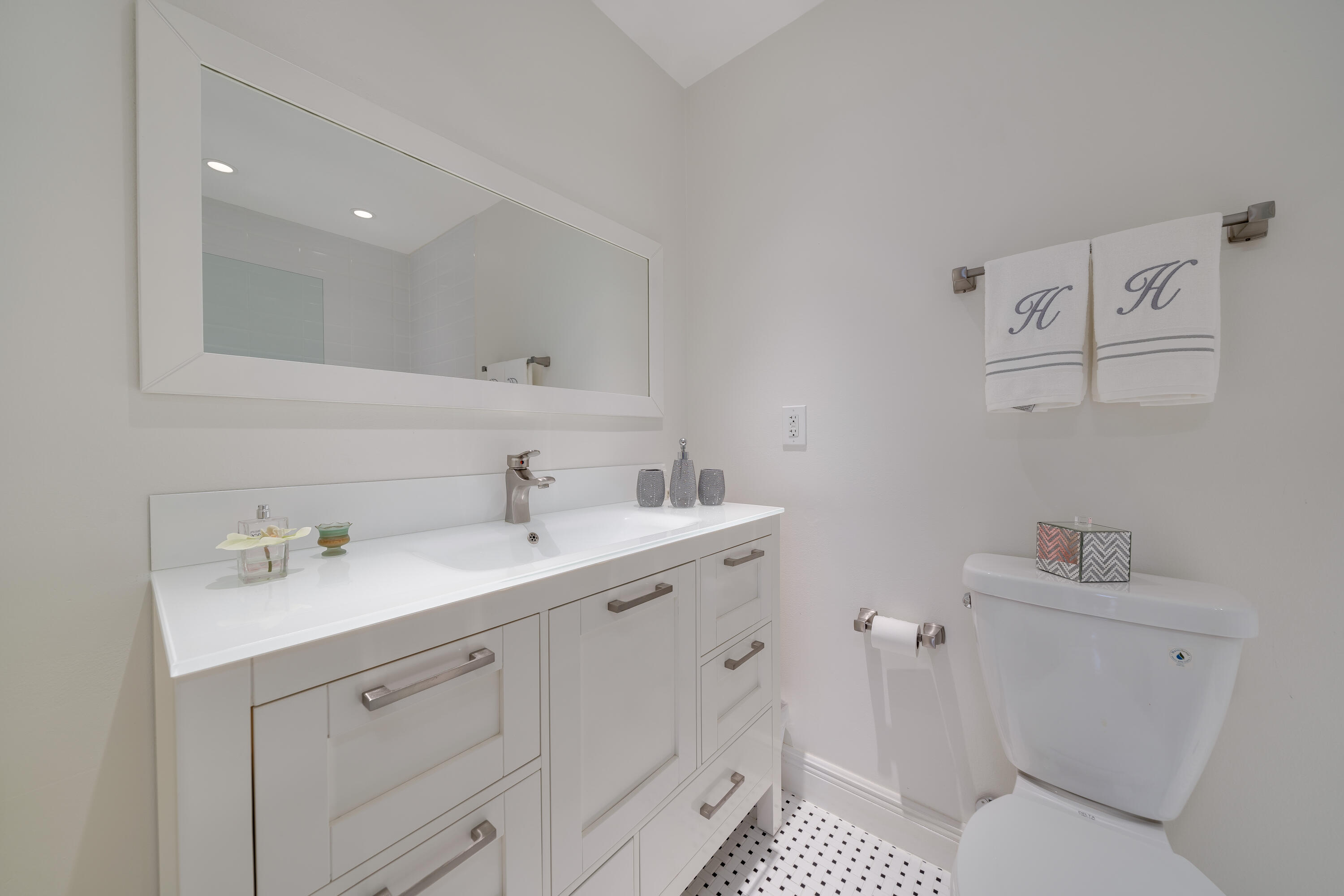14240 Nesting Way, Unit D Delray Beach, FL 33484 - Photo 6 of 45 a spacious bathroom with a toilet sink and mirror
