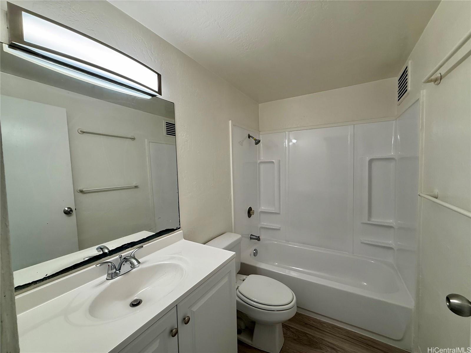 87-134 Helelua Street, Unit A302 Waianae, HI 96792 - Photo 11 of 16 a bathroom with a sink mirror toilet and bathtub