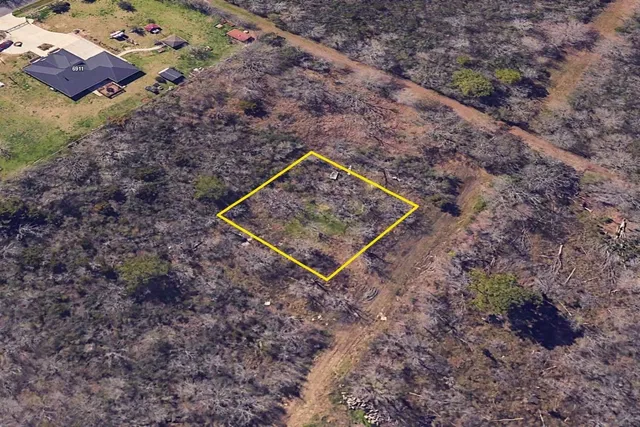 a wooden bench sitting in the middle of a field