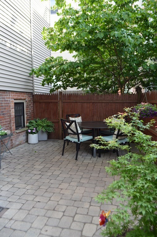 62 Sullivan Street, Unit 1 Boston, MA 02129 - Photo 11 of 11 a view of a backyard with chairs and a fire pit