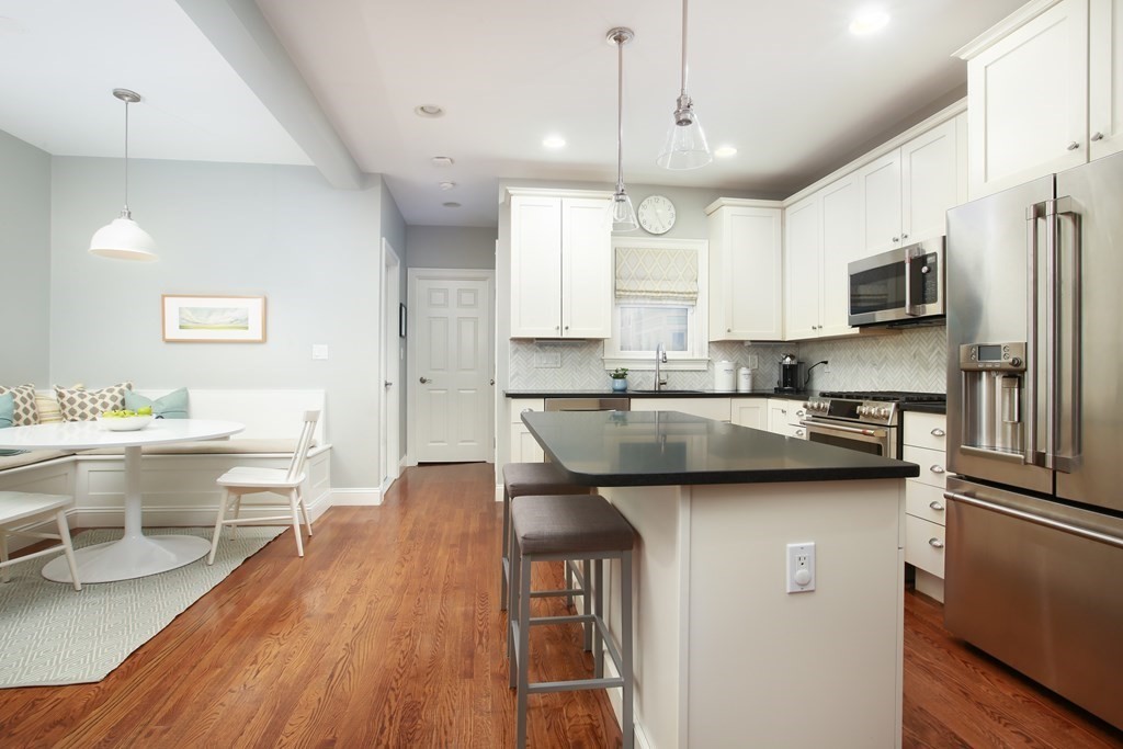 62 Sullivan Street, Unit 1 Boston, MA 02129 - Photo 2 of 11 a kitchen with stainless steel appliances a sink stove refrigerator and microwave