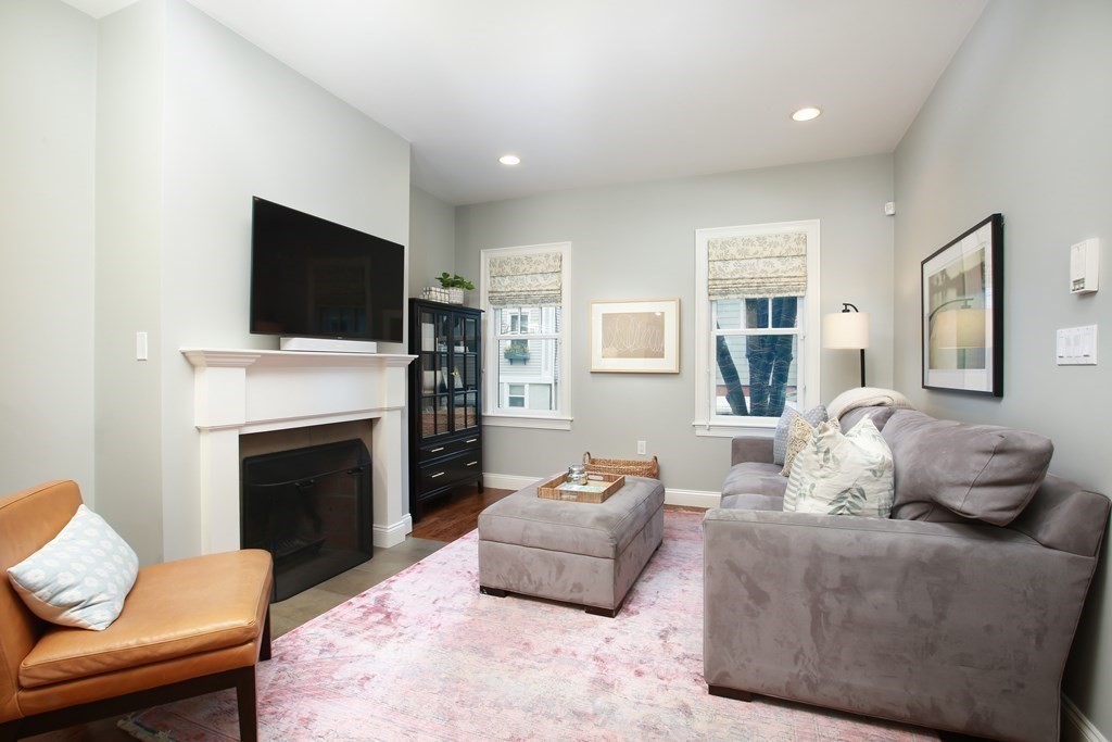 62 Sullivan Street, Unit 1 Boston, MA 02129 - Photo 4 of 11 a living room with furniture a flat screen tv and a fireplace