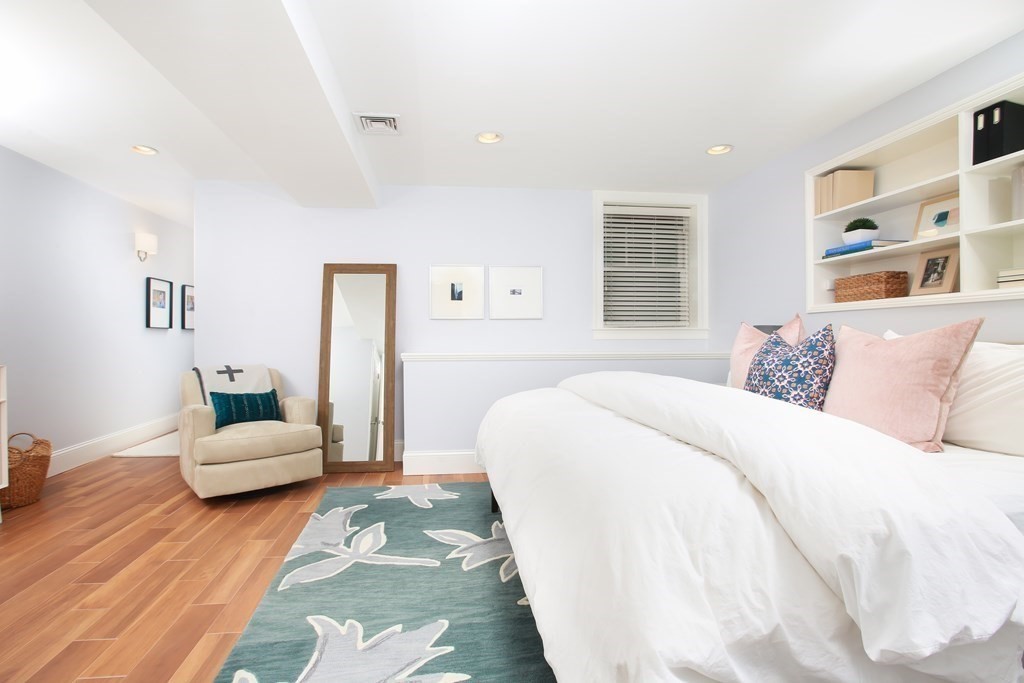 62 Sullivan Street, Unit 1 Boston, MA 02129 - Photo 5 of 11 a bedroom with a bed and wooden floor