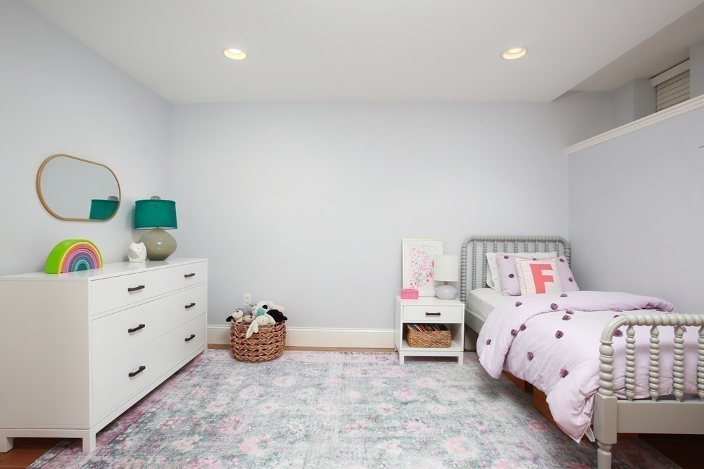 62 Sullivan Street, Unit 1 Boston, MA 02129 - Photo 9 of 11 a bedroom with a bed and a dresser