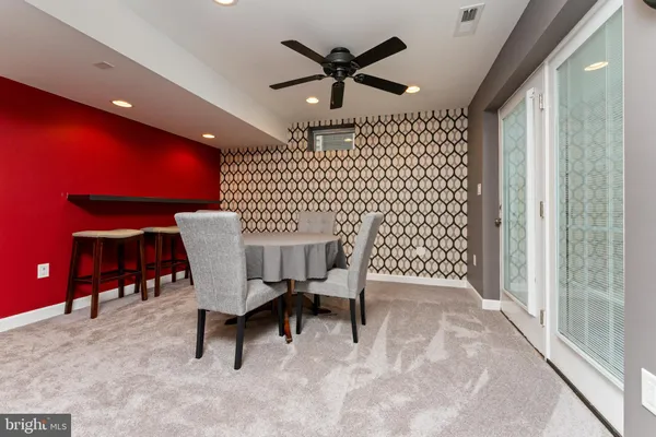 a dining room with furniture and a chandelier