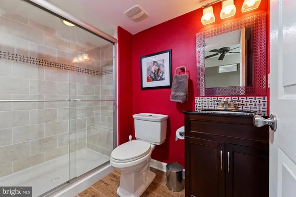 a bathroom with a toilet a sink and mirror
