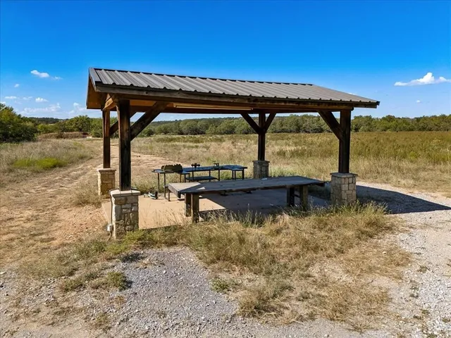 a backyard of a house with lake view yard table and chairs