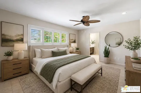 a bedroom with bed and a chandelier