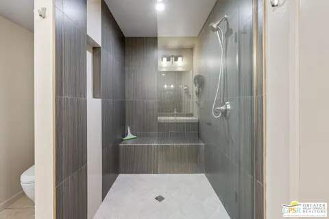 a bathroom with a shower and toilet