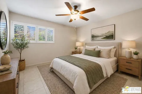 a bedroom with a bed and a potted plant