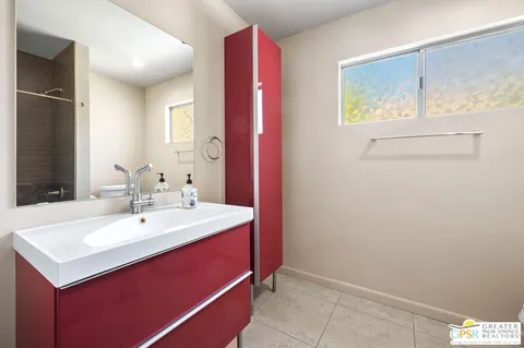 a bathroom with a sink vanity and a mirror