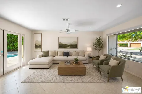 a living room with furniture and a large window