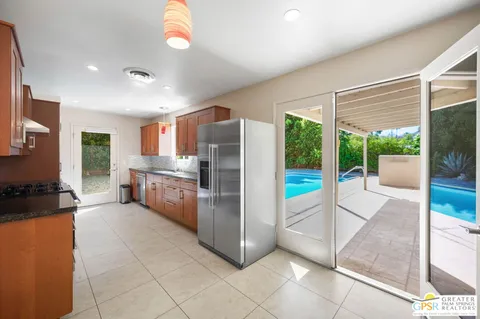 a large kitchen with a large window and stainless steel appliances
