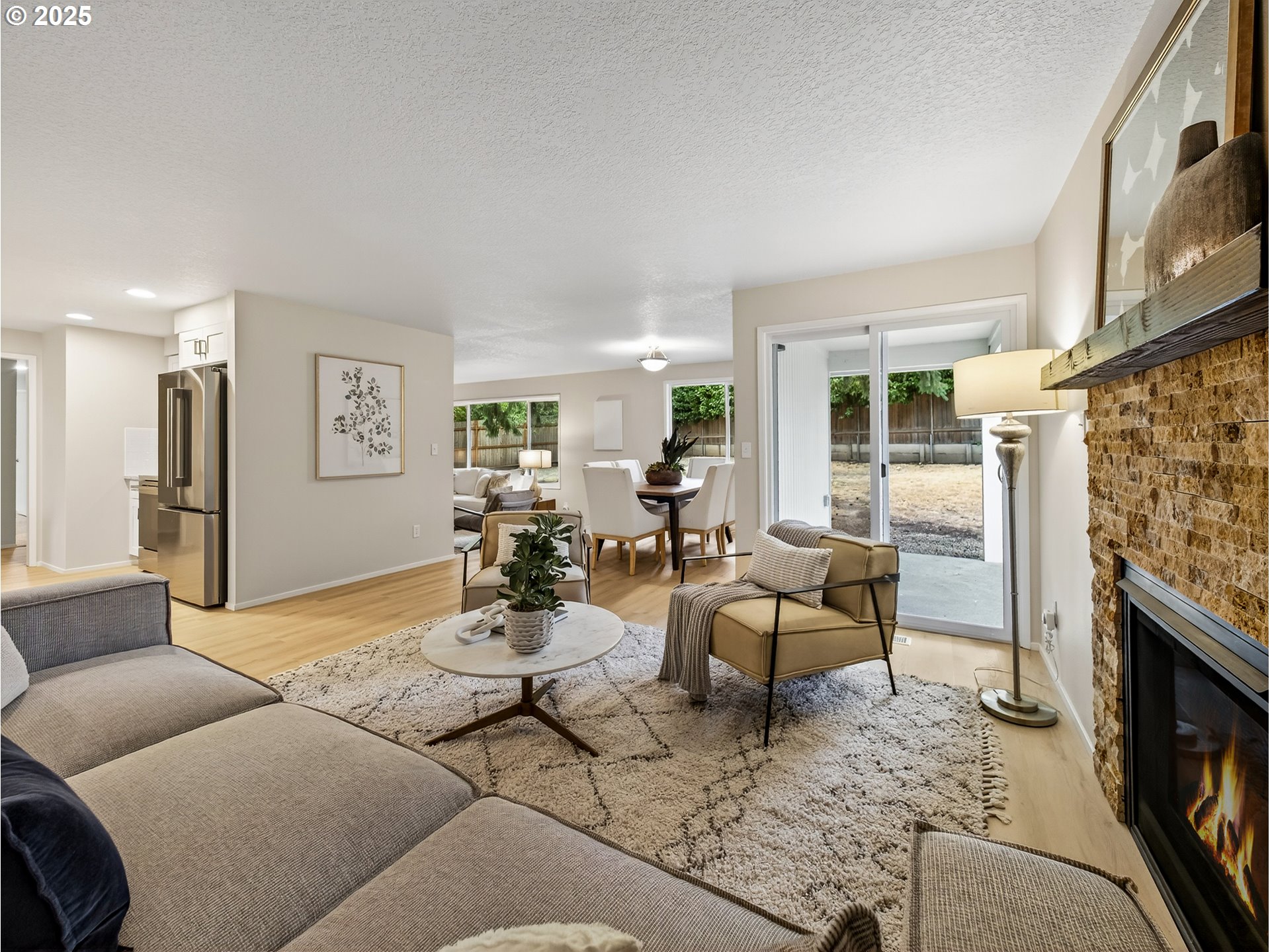 12945 Southwest Hackamore Court Beaverton, OR 97008 - Photo 15 of 48 a living room with furniture wooden floor and a fireplace