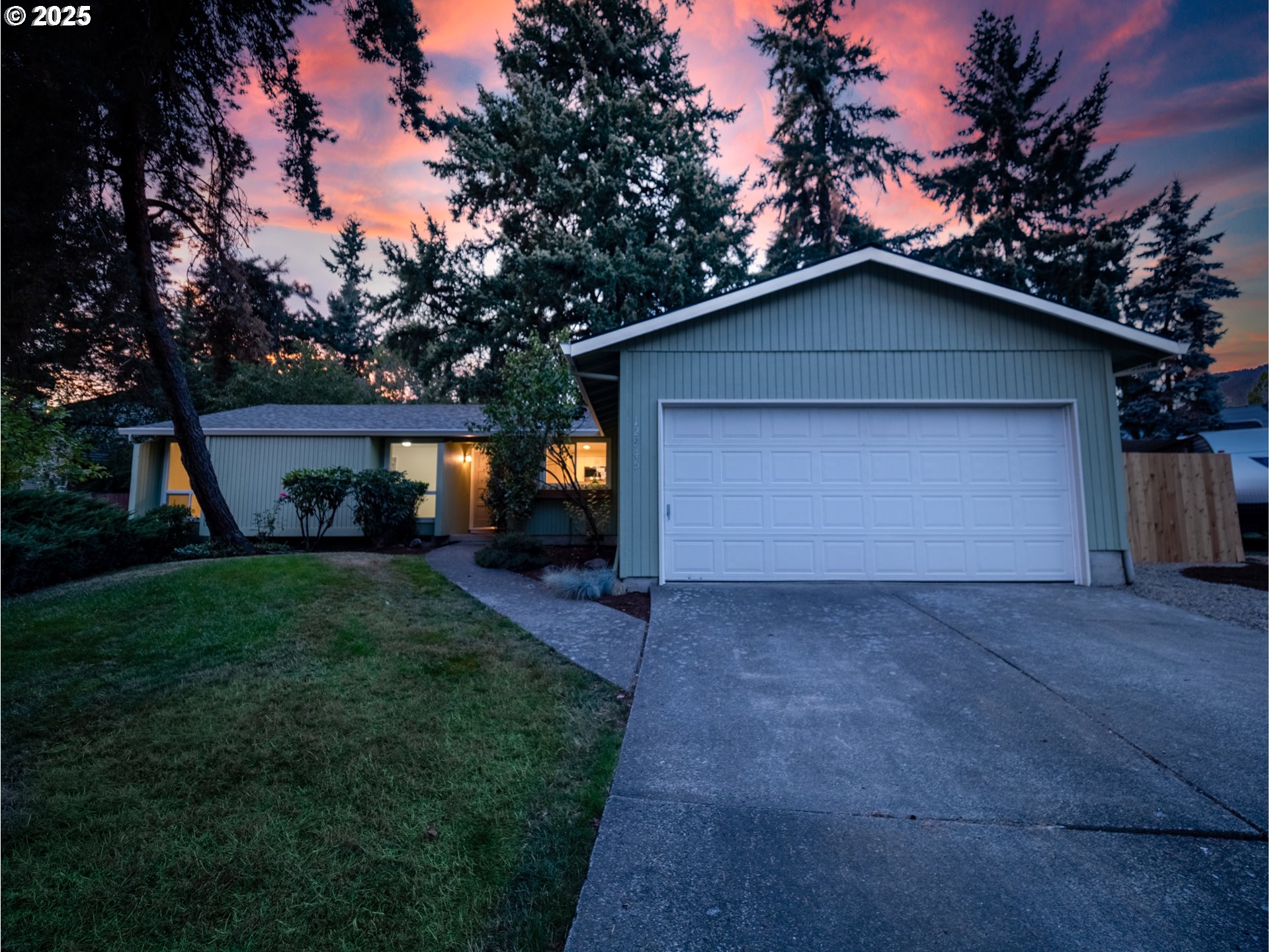 12945 Southwest Hackamore Court Beaverton, OR 97008 - Photo 2 of 48 a view of backyard of house with wooden fence