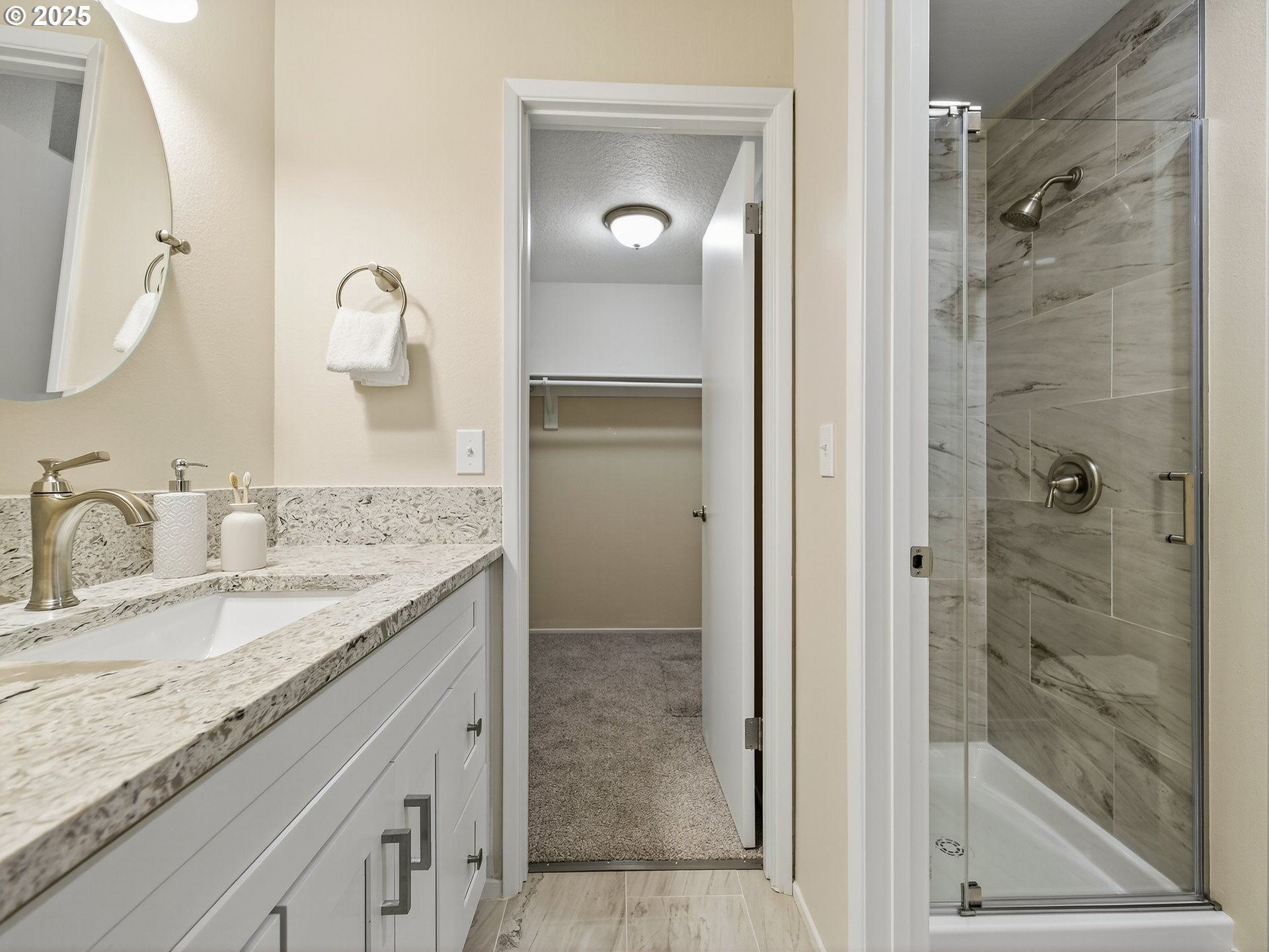 12945 Southwest Hackamore Court Beaverton, OR 97008 - Photo 27 of 48 a bathroom with a granite countertop sink mirror and shower