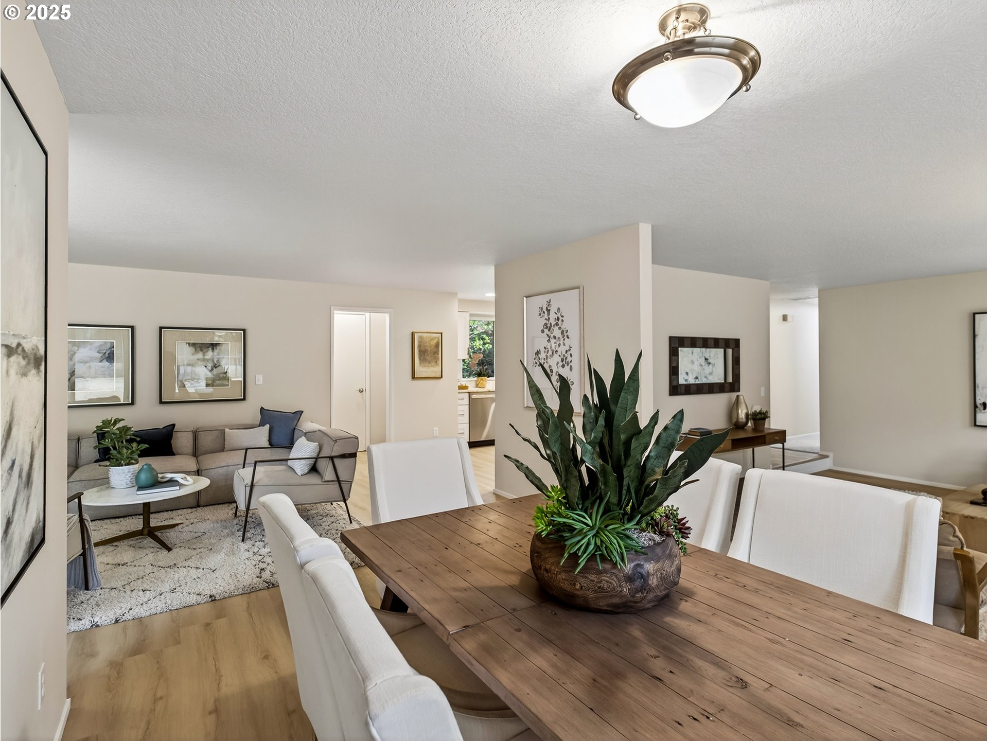 12945 Southwest Hackamore Court Beaverton, OR 97008 - Photo 45 of 48 a view of a dining room with furniture a potted plant and wooden floor