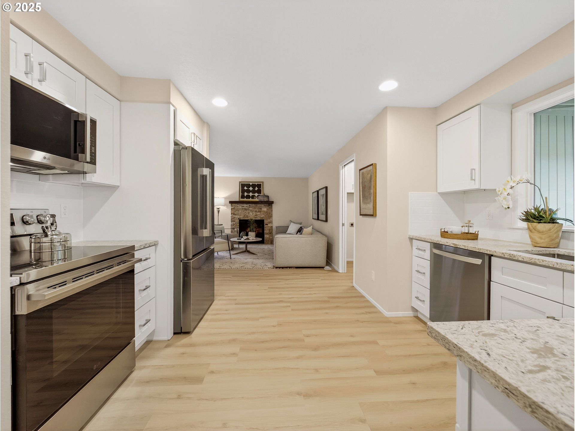 12945 Southwest Hackamore Court Beaverton, OR 97008 - Photo 6 of 48 a large white kitchen with stainless steel appliances granite countertop a stove top oven a sink dishwasher and wooden cabinets