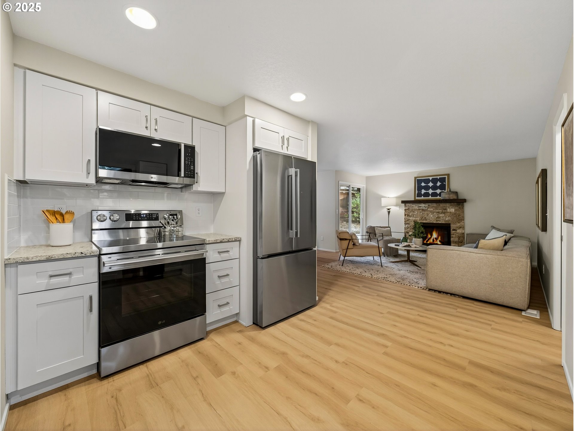 12945 Southwest Hackamore Court Beaverton, OR 97008 - Photo 7 of 48 a kitchen with a refrigerator stove top oven and cabinets