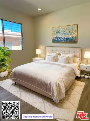 a bedroom with a bed and a painting on the wall