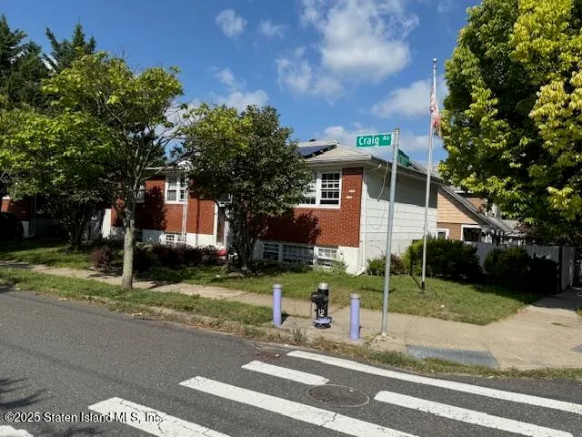 a view of a house with a yard and tree s